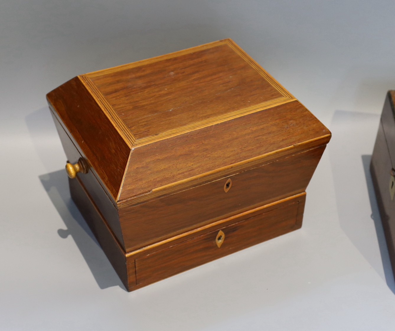 A Victorian mahogany sarcophagus work box, width 30 cms, a Victorian walnut sewing box and three others.